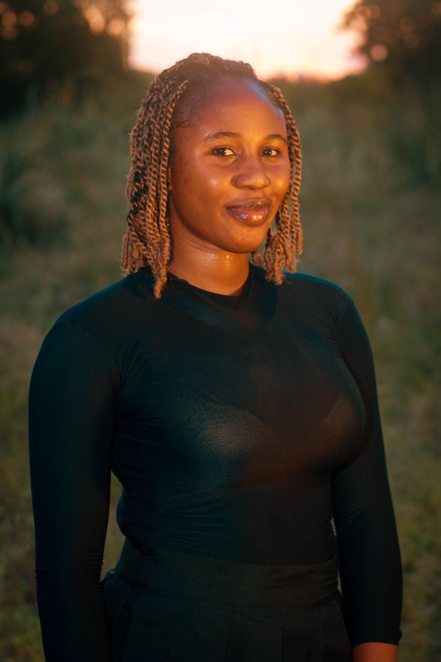 Portrait of a smiling woman outdoors at golden hour